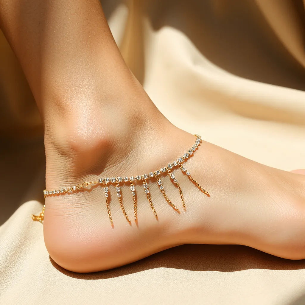 Gold rhinestone fringe anklet with sparkling stones and dangling fringe on a neutral background