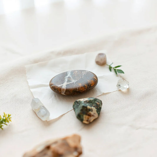 Polished eco-friendly crystal pieces arranged on a neutral surface with soft natural light