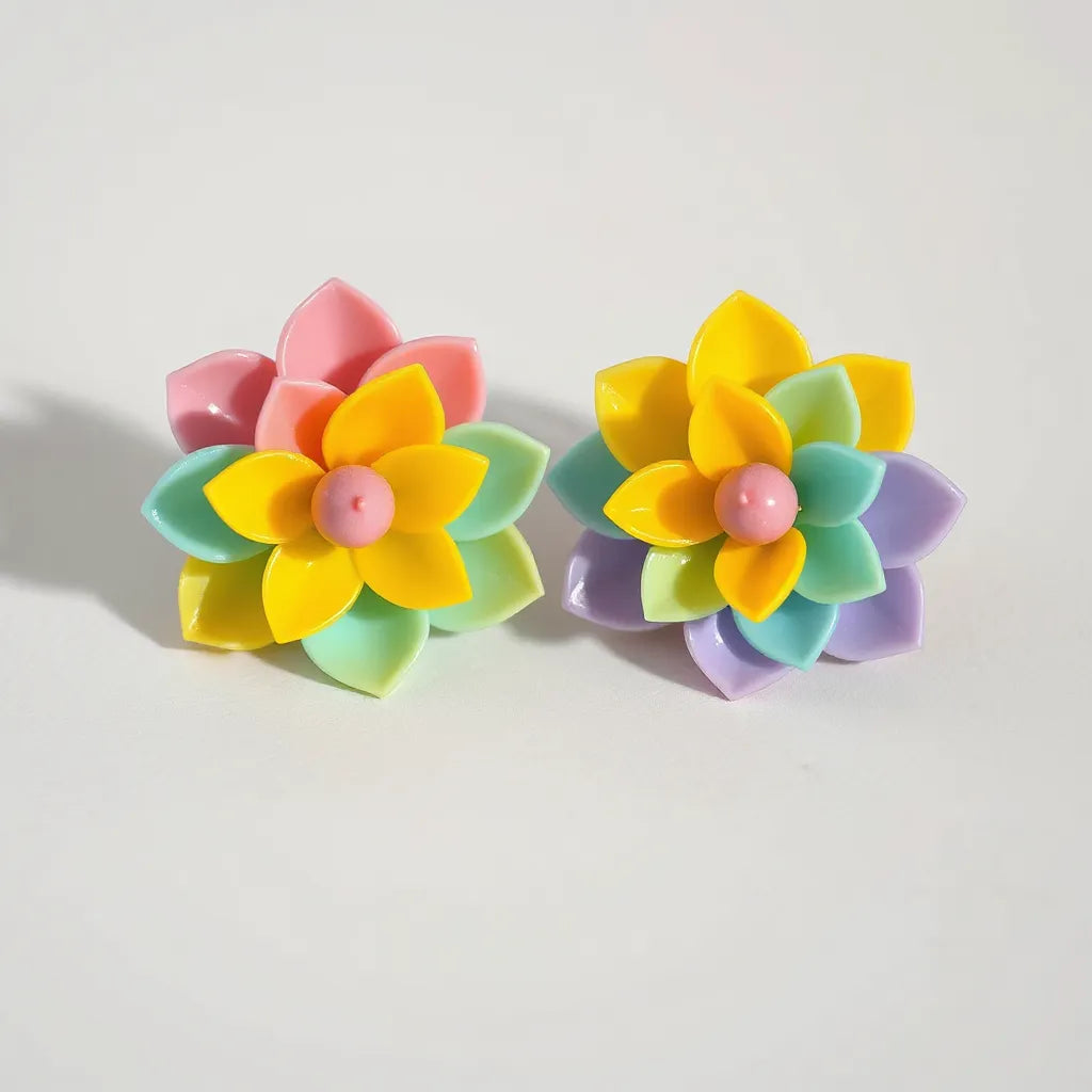 Oversized multicolor acrylic flower stud earrings with layered glossy petals on a neutral background